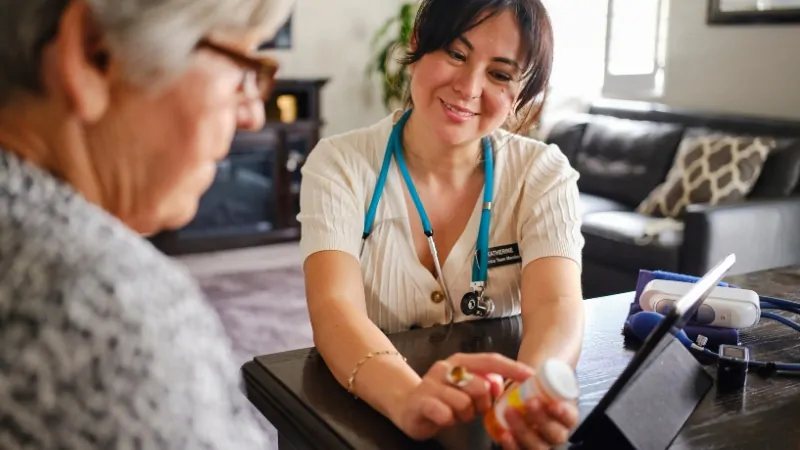 Healthcare provider discussing medication and treatment options with an older adult