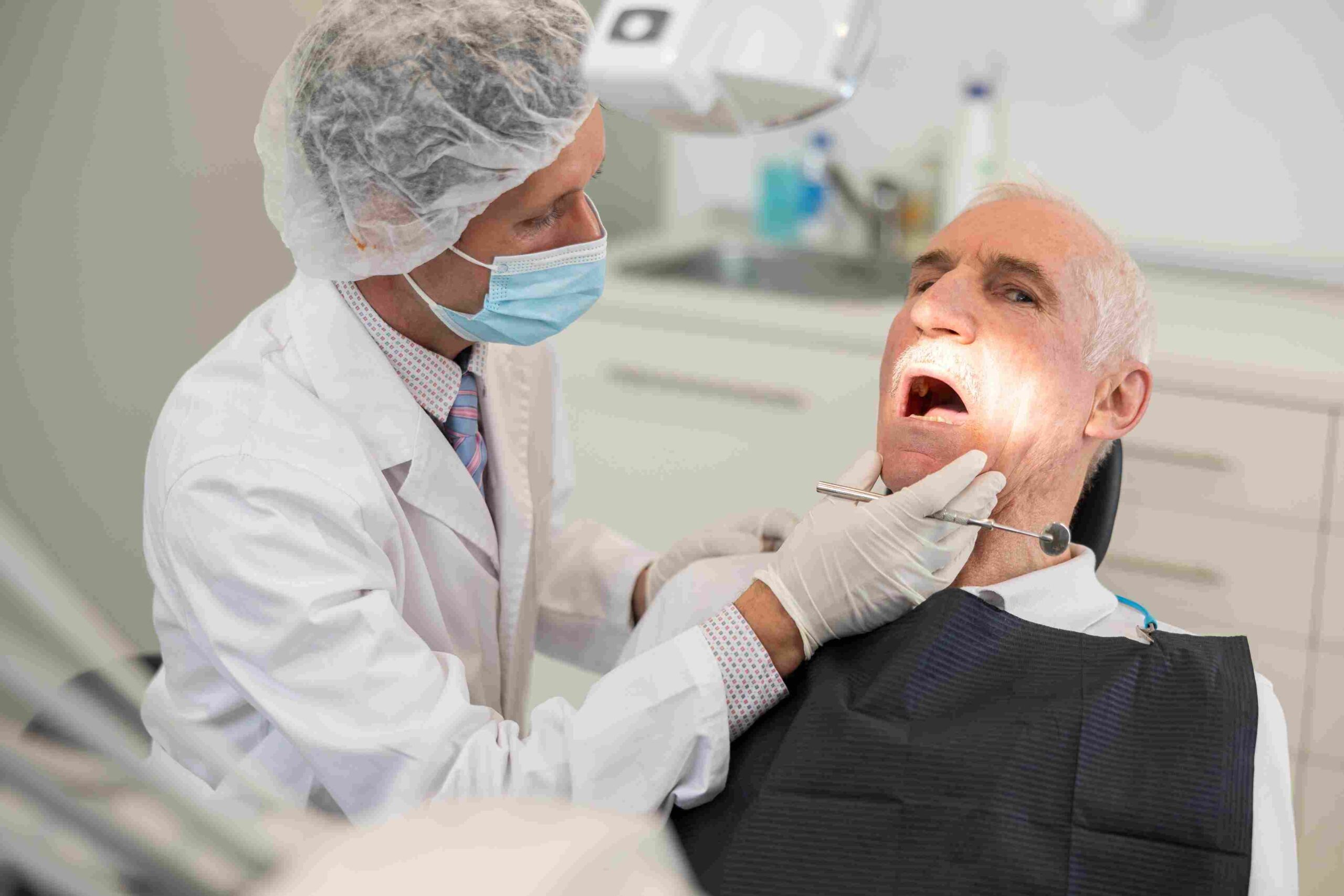 Dentist examining an elderly patient during a dental checkup