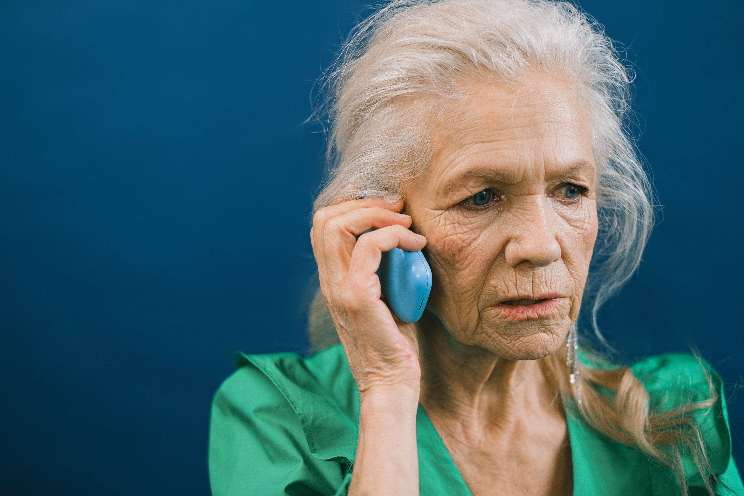 Senior woman talking on her mobile phone, illustrating how Medicare scam calls may target older adults.